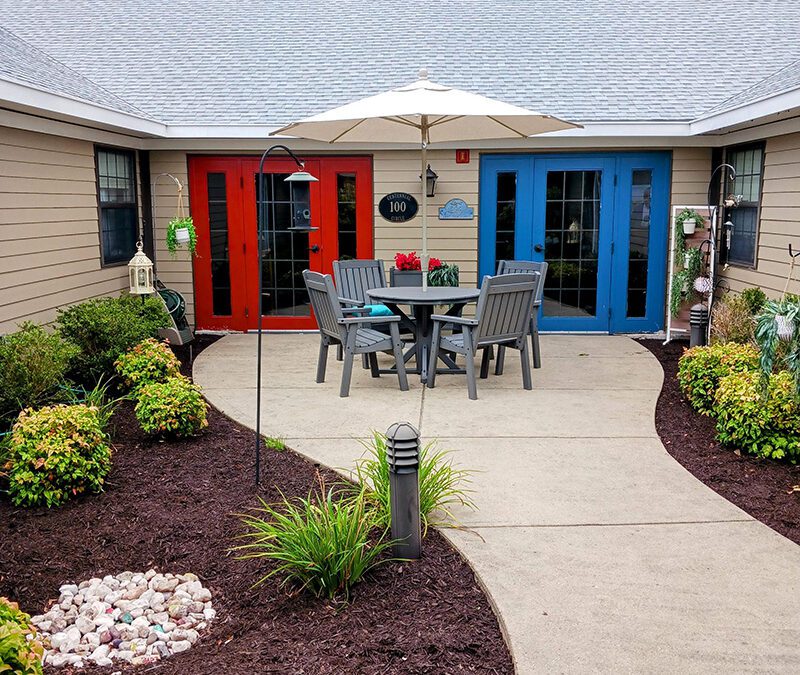 outdoor porch with plants, sun umbrella and seating