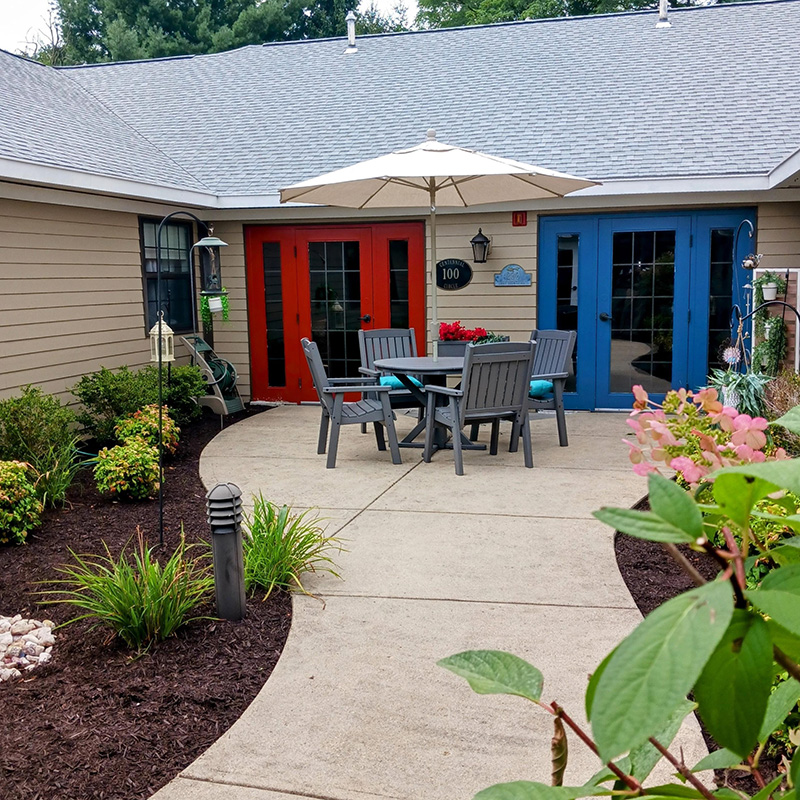 outdoor patio surrounded by flowers and bushes