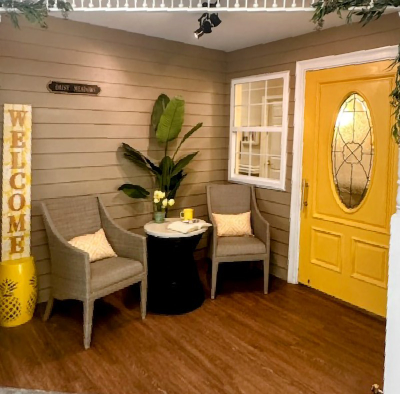 front porch with chairs and plants