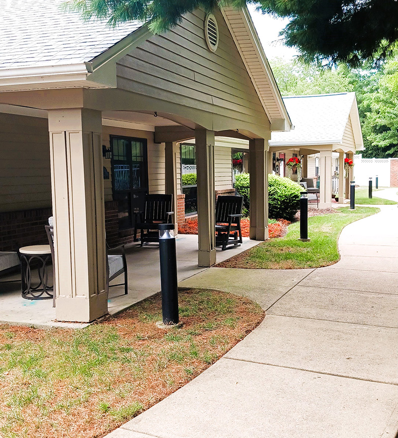 neighboring front porches with cozy furniture