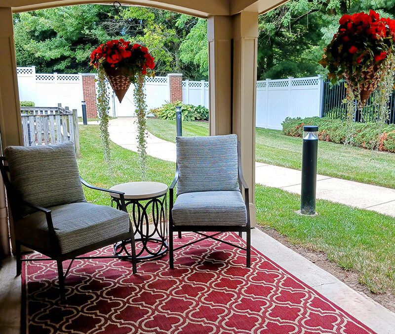 shaded porch with rug, seating and plants