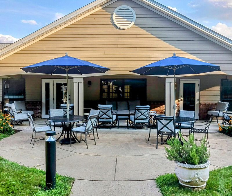 front porch with sun umbrellas and seating