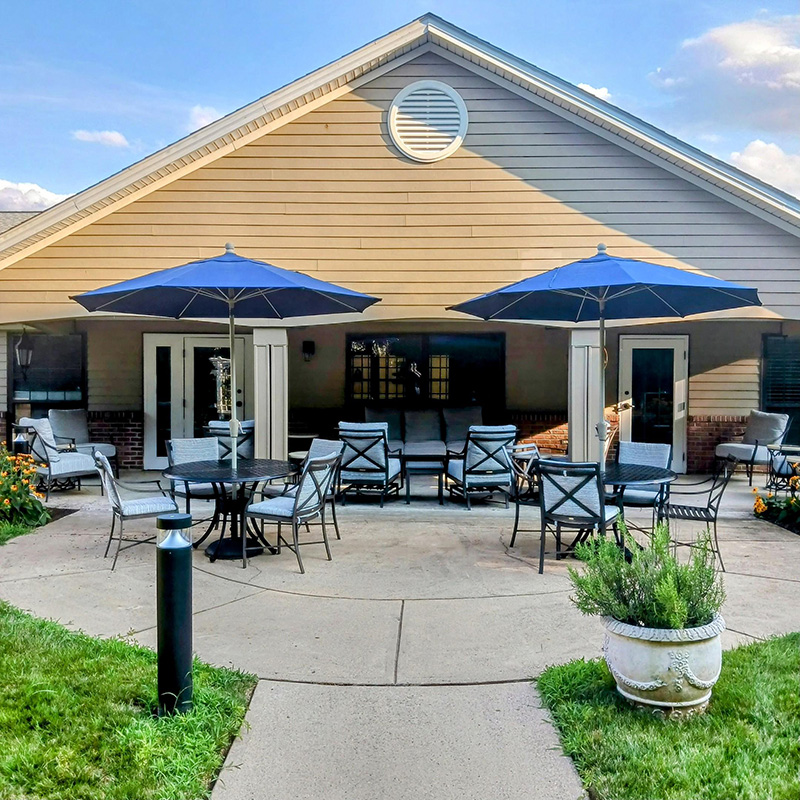 front porch with sun umbrellas and seating